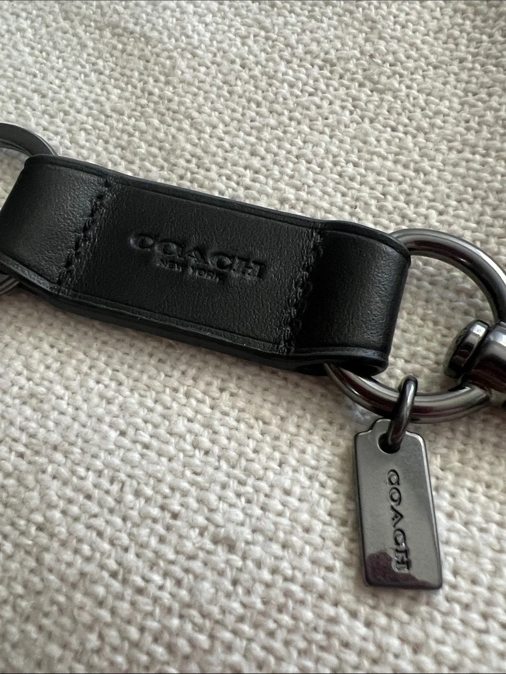 Coach Trigger Snap Key Fob black leather and silver-toned hardware.